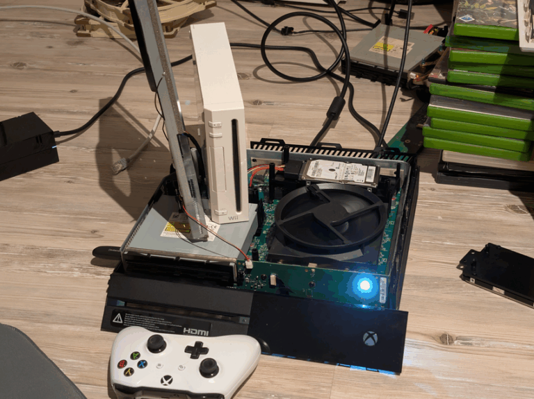 Xbox One original with hard drive exposed and white controller